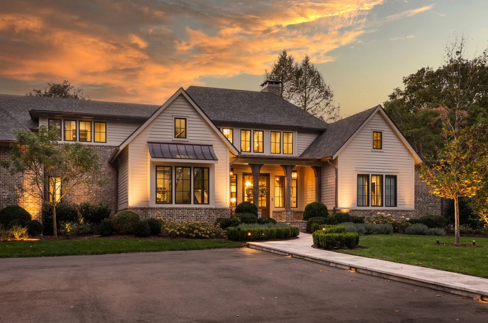 A porch-fronted Southern home framed by palms